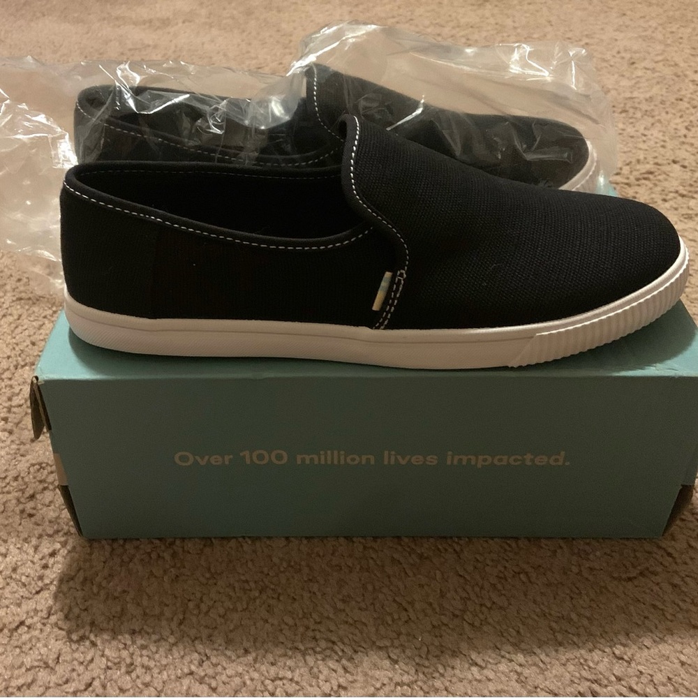 New black toms slide on shoes.
